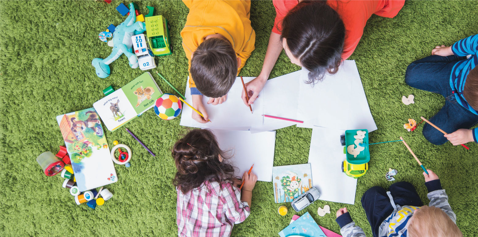 Children drawing together in a park